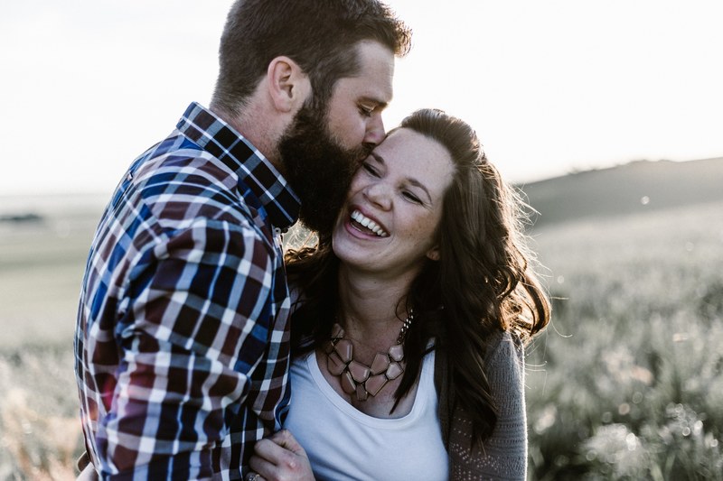 boyfriend kissing his smiling happy girlfriend on the cheek, happy couple kissing 4k