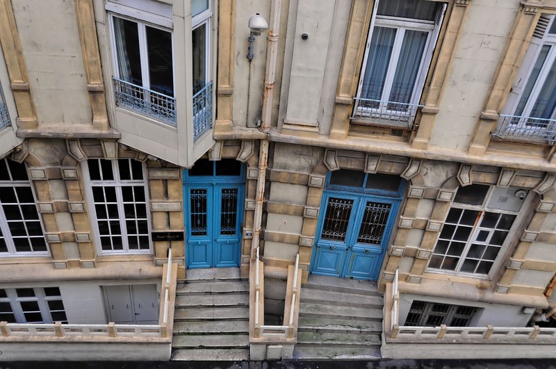 an overhead shot of old buildings with blue doors in rue gustave rouland, _room with city view 4k