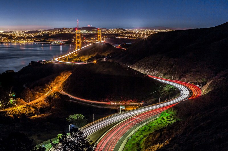 long exposure of san francisco traffic at night with the golden gate bridge in the background, a different view of the bridge 4k