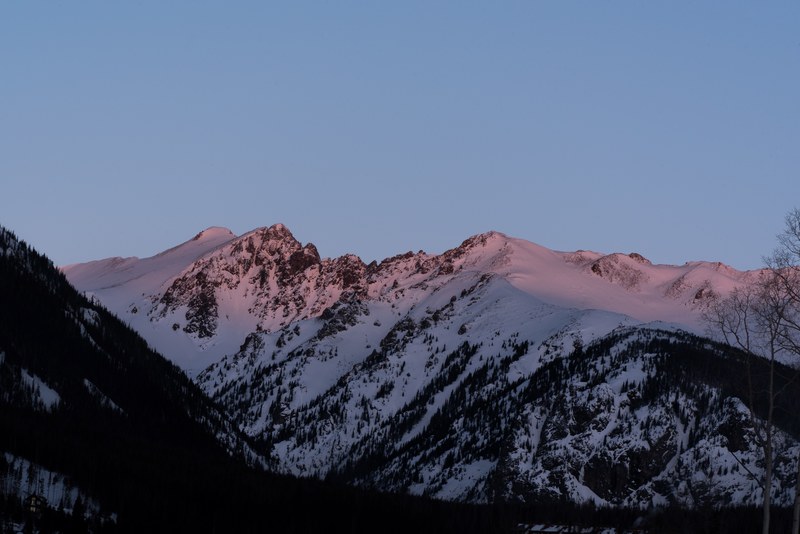 red sunrays falling on a mountain ridge during sunset, reddish mountain ridge 4k
