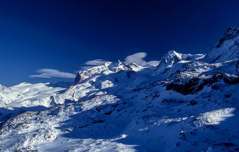 snowy mountains covered by shadows of clouds, winter in the mountains 4k