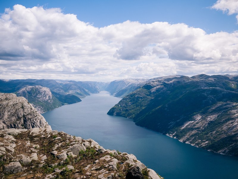 a panorama of a river winding through rocky hills covered with shrubs, winding river under clouds 4k