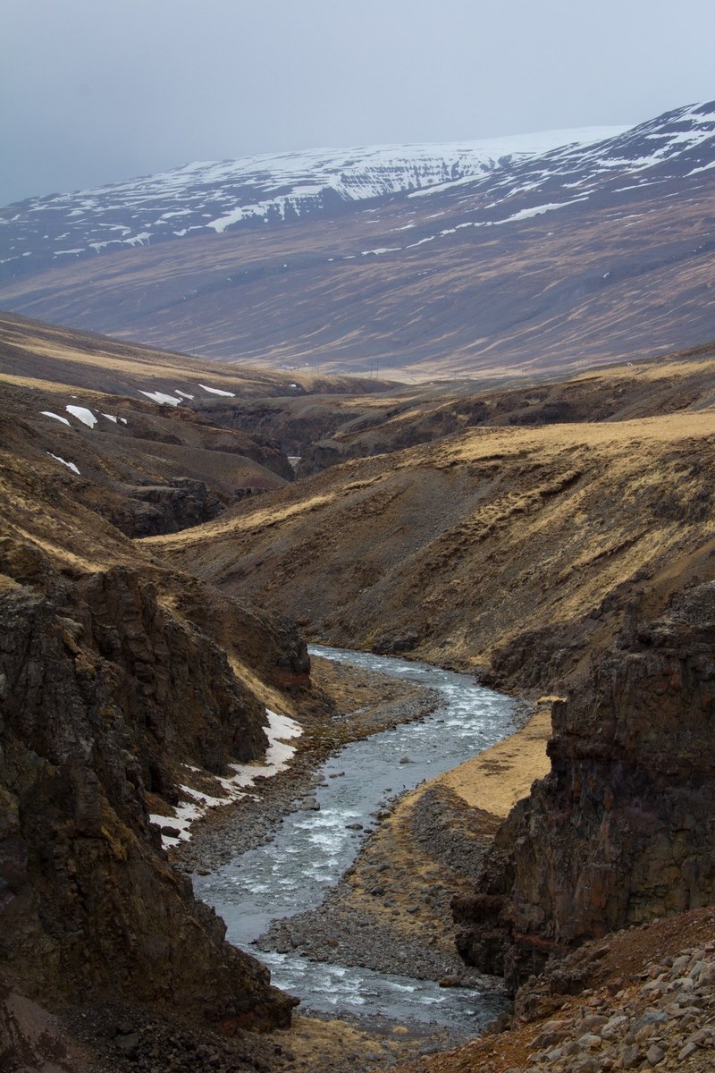 river flowing through a rocky valley with the mountains in the background, river across the valley 4k