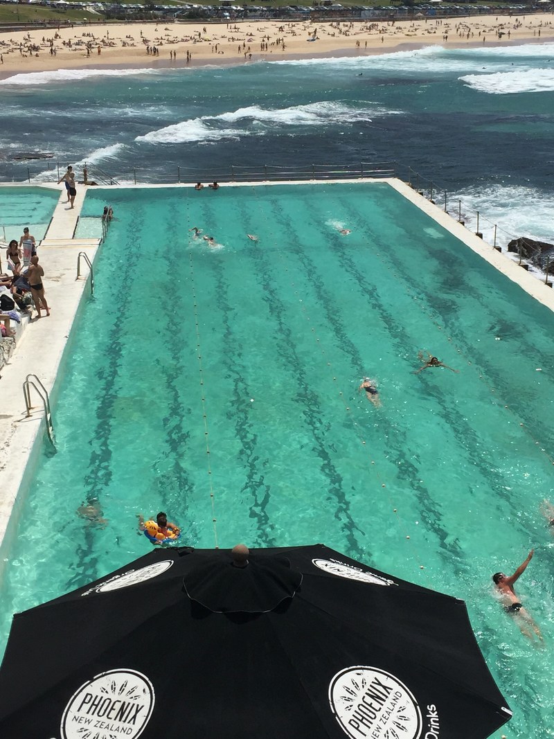 exotic swimming pool in front of bondi beach features fun loving people relaxing, swimming pool at bondi 4k