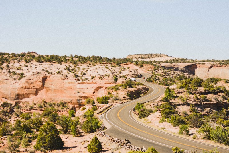 highway road curves through the desert of canyonlands national park, the long and winding road 4k