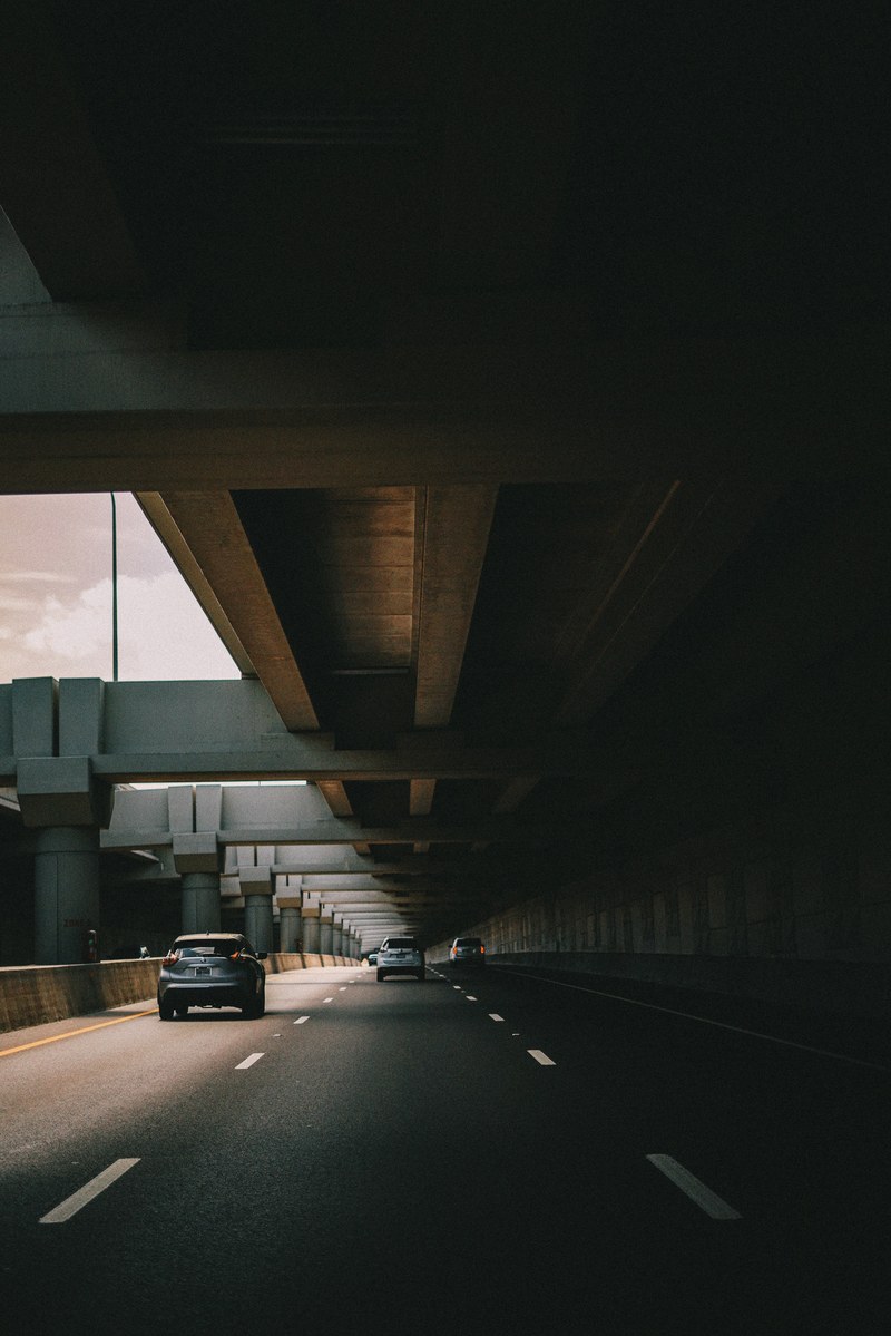a road with little traffic at an underpass in dallas, _under the bridge 4k