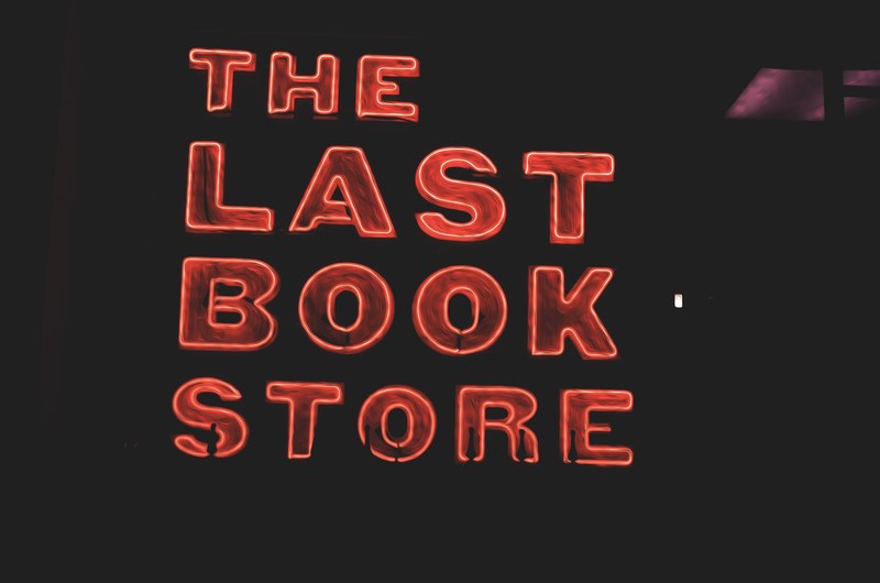 a glowing red neon reading the last book store, the last book store 4k
