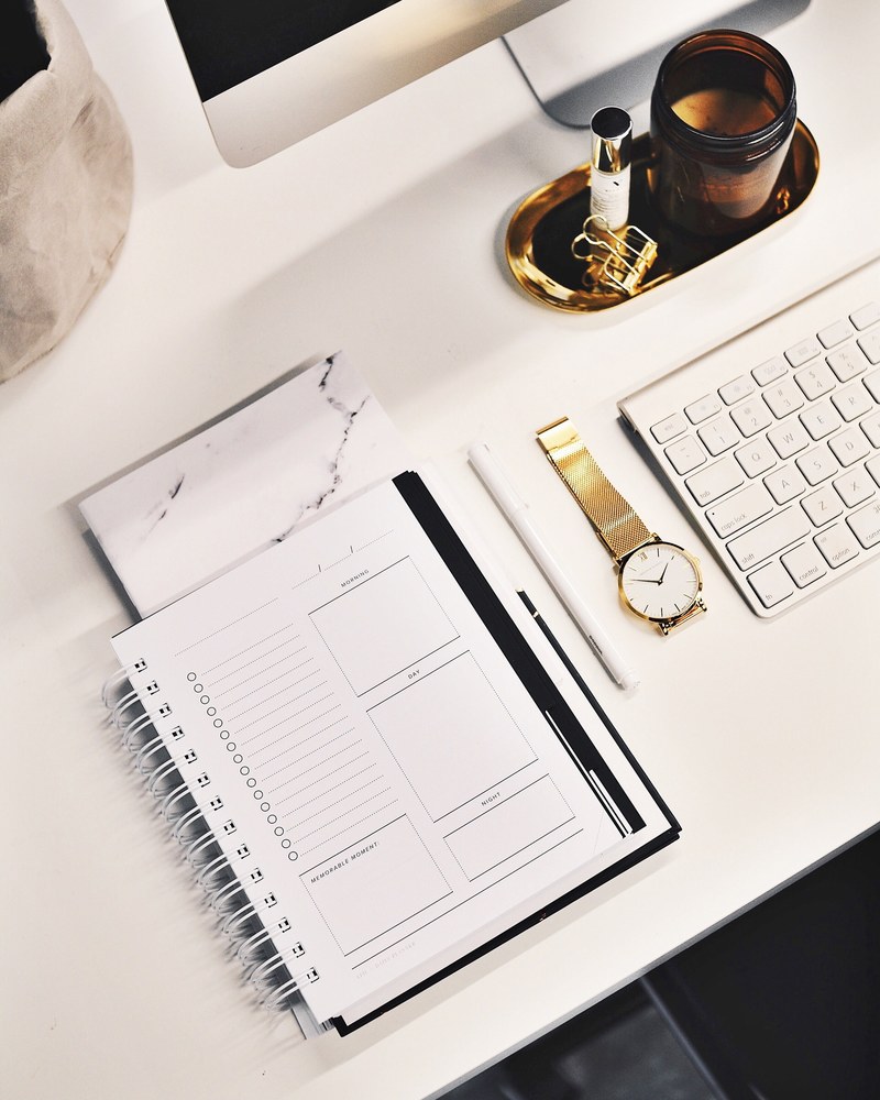 a flatlay image of a desk with a keyboard gold watch notebook and more, _white on white 4k