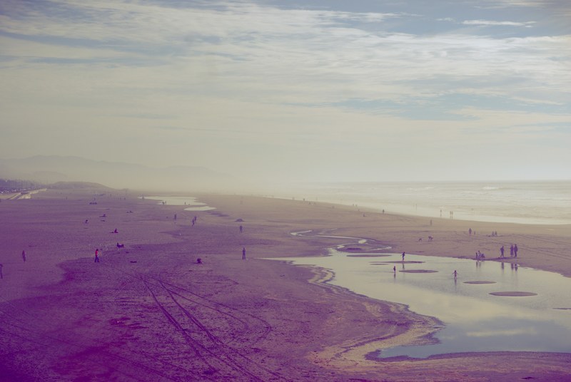 people on the big sand beach with ocean puddles, people on big sand beach 4k