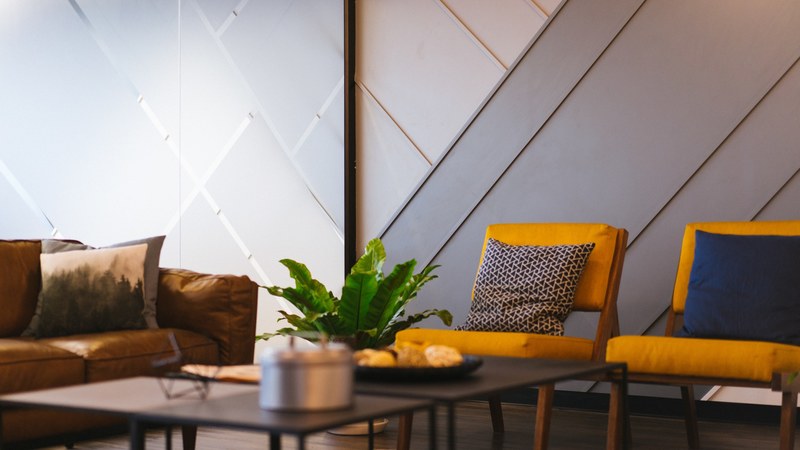 two chairs and a sofa in a coworking space, casual meeting room 4k