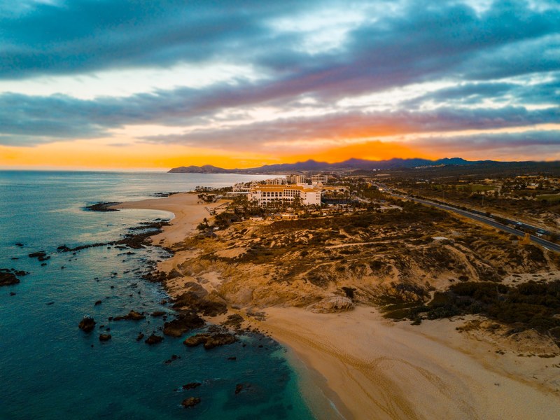 an orange sunset over a quiet coastal beach in san jos del cabo, sunset over san jos del cabo beach 4k