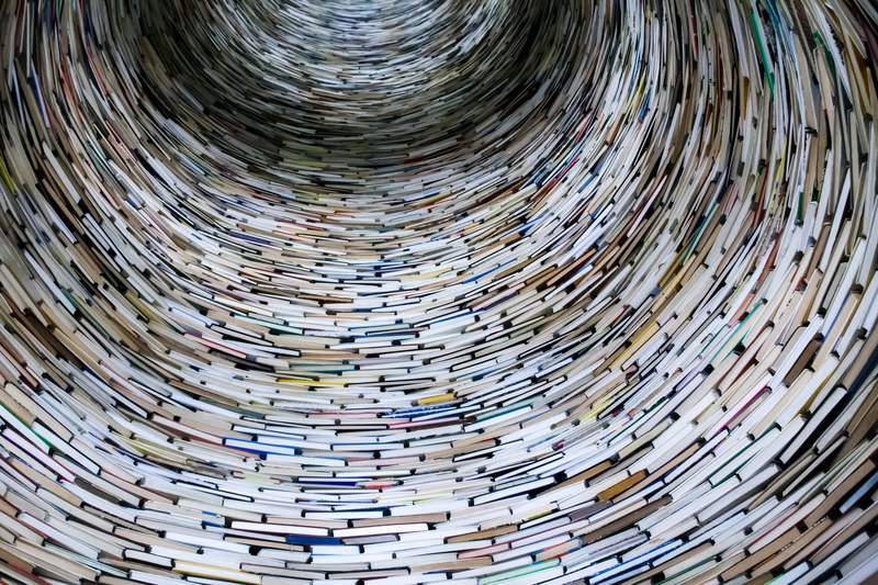 a round circle made up of books looking like a tunnel, simply books_ 4k