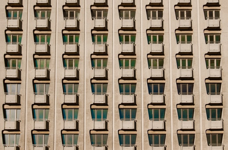 regular rows of tiny balconies on an old apartment building, rows of balconies 4k