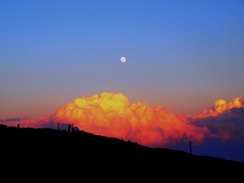 full moon rises over puffy orange clouds during sunset in krim, golden clouds and full moon sunset at krim_ 4k