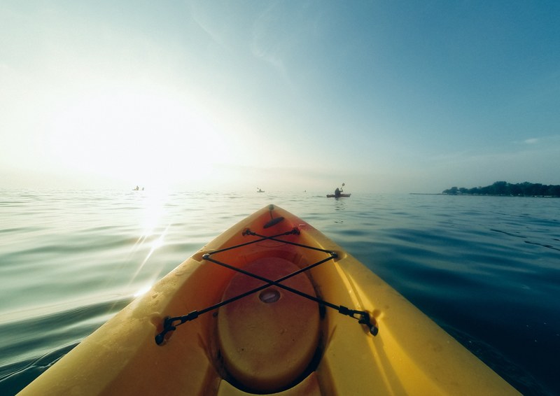 a yellow kayak floating on a lake, yellow kayak lake 4k