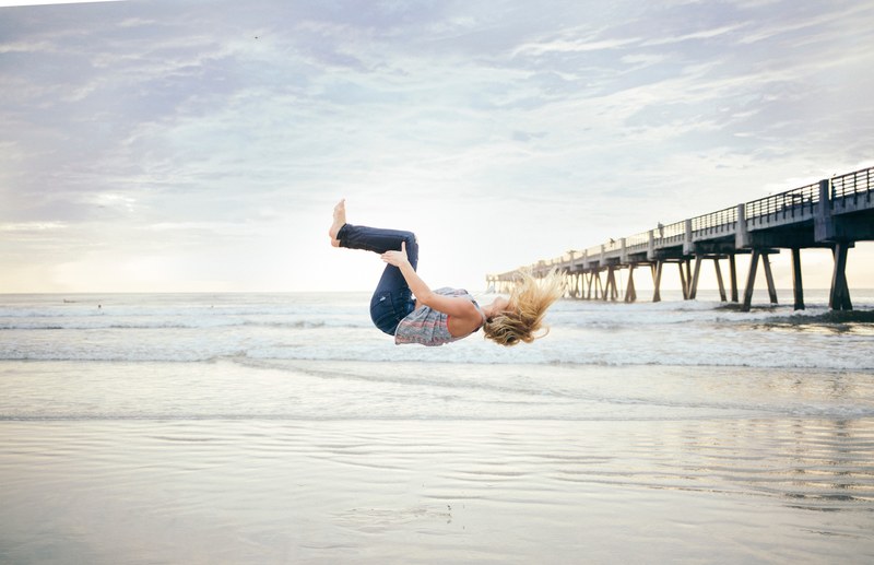 a woman doing a backflip at the beach, _beach backflip 4k