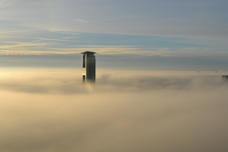 city skyscraper peeks through the clouds on a sunny day, buildings in the sky 4k