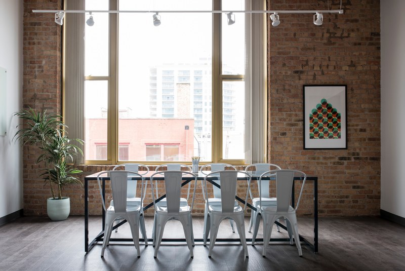plastic chairs at a table in a small meeting room, cramped meeting room 4k