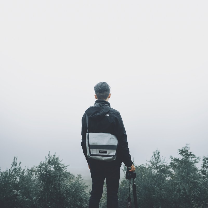 a man standing out into the foggy clouds from the top of a mountain, dear fog tell me 4k