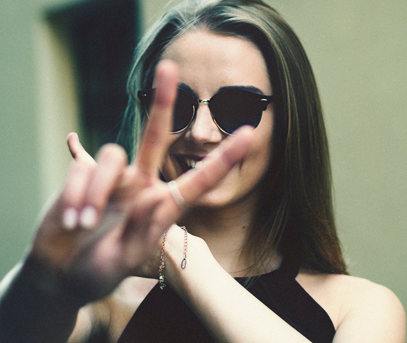 a young woman in sunglasses making a peace sign with her fingers, victoria 4k