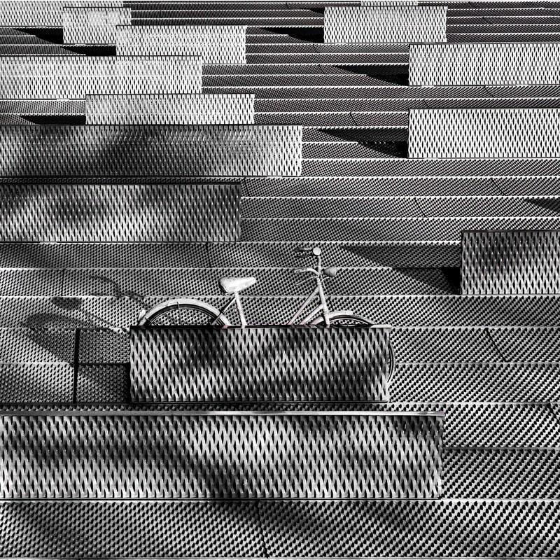 a gray bicycle parked on a gray latticework surface, the bike 4k