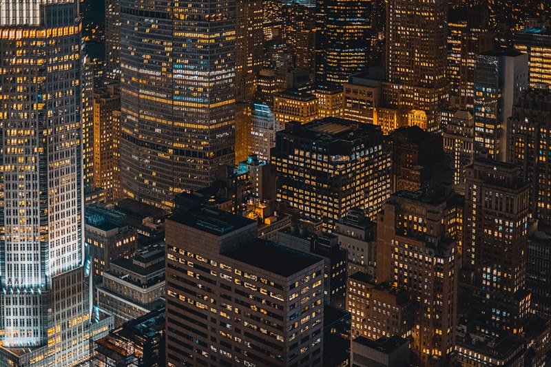 night in a big city with orange highlights along the streets and in the windows, city building lights at night 4k