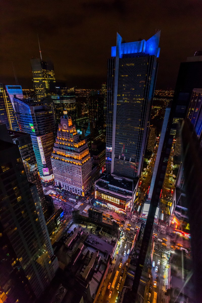 a high shot of neon soaked skyscrapers in new york at night, manhatten night 4k
