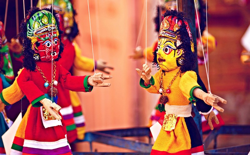 a cast of ornate puppets on strings acting out a play, puppets on strings 4k