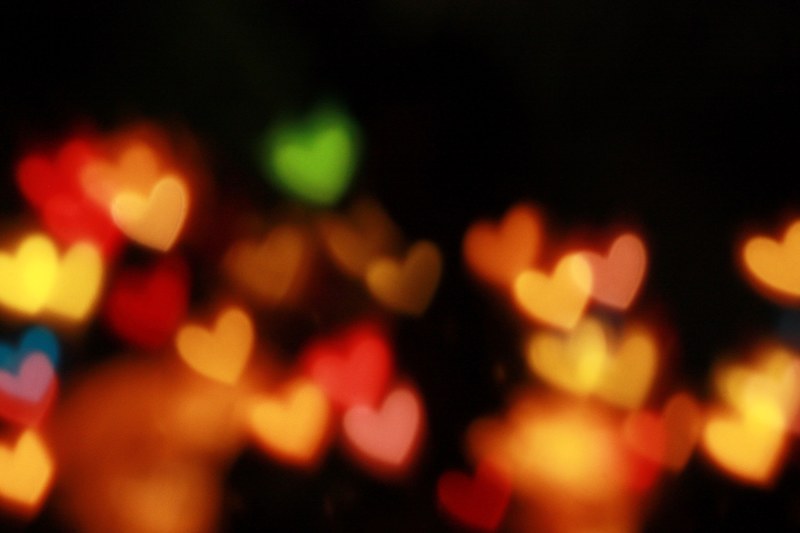 illuminated multi colored hearts against a black backdrop, light up hearts 4k