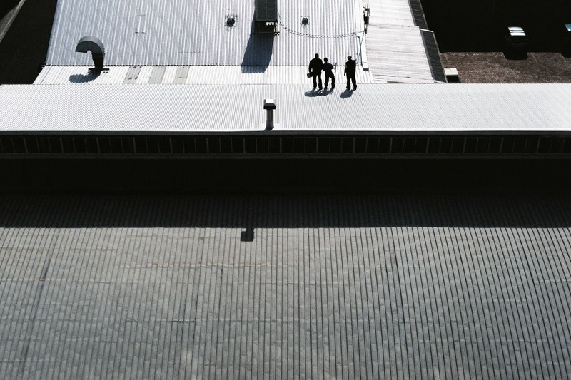 shadows of men working on rooftop in woodstock, roof work woodstock 4k