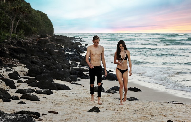 couple in swimsuits walking on the sand beach, couple in paradise_ 4k