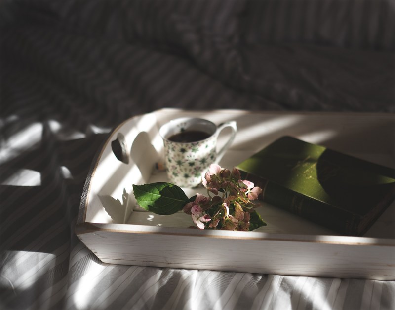 a book a cup of coffee and a cluster of hydrangea flowers on a wooden tray, book and coffee 4k