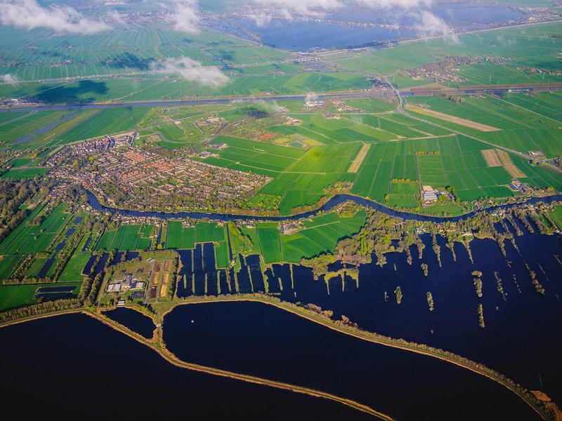 aerial drone shot of a rural farm land and village in netherlands, flying over netherlands 4k