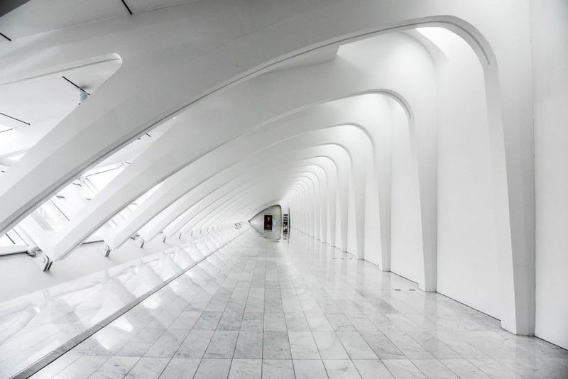 a long white corridor with a marble floor under a modern ribbed ceiling, modern white corridor 4k