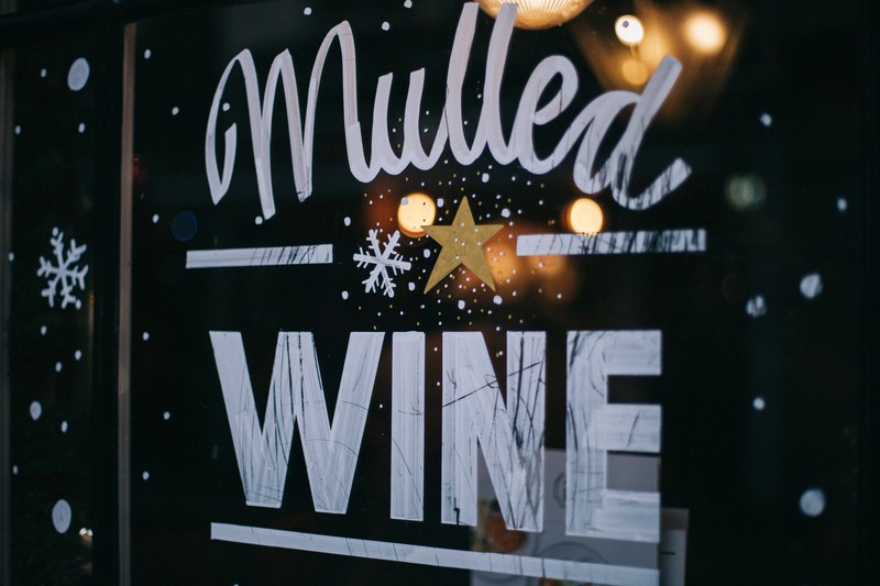 an artwork reading mulled wine on a glass window of a store in soho, vino de crimbo 4k