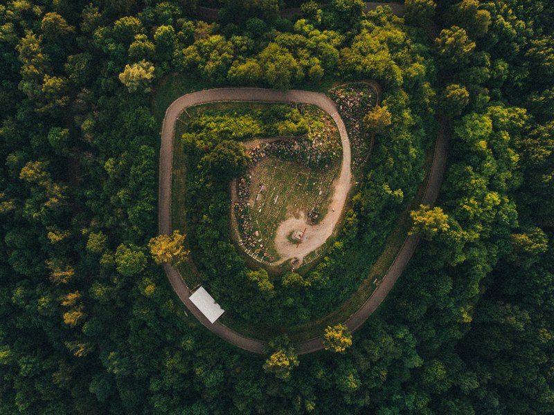a drone shot of a spiral road in a forest, monte scherbelino stuttgart 4k