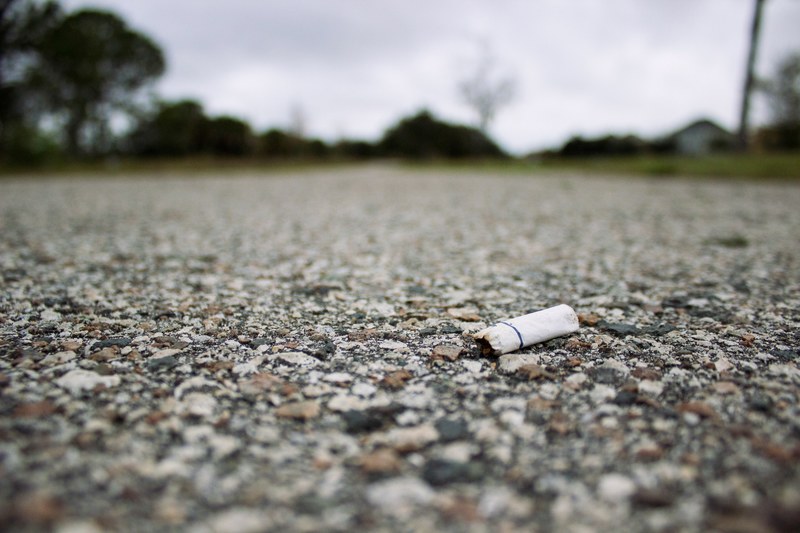 cigarette road cigarette butt and gravel 4k
