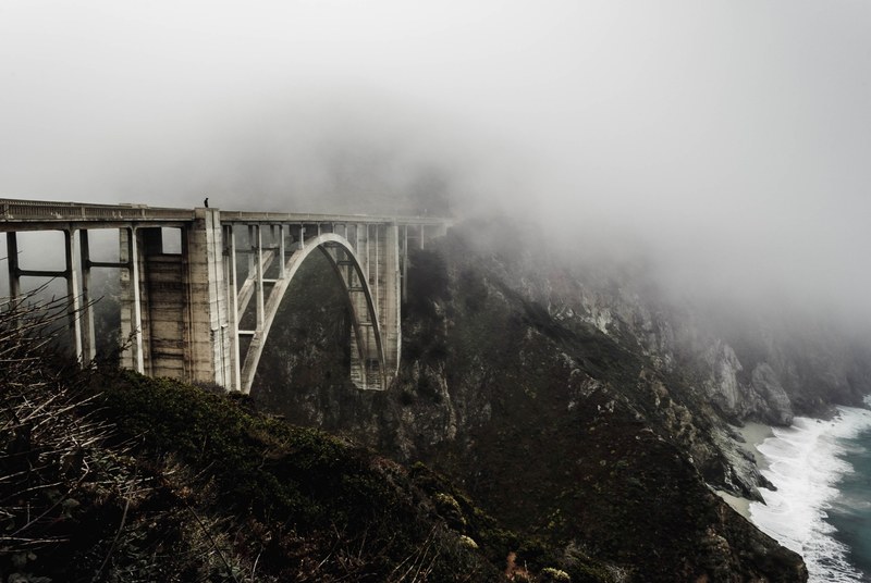 desolate bridge on a mountainside in california overlooks the beach, desolate bridge 4k