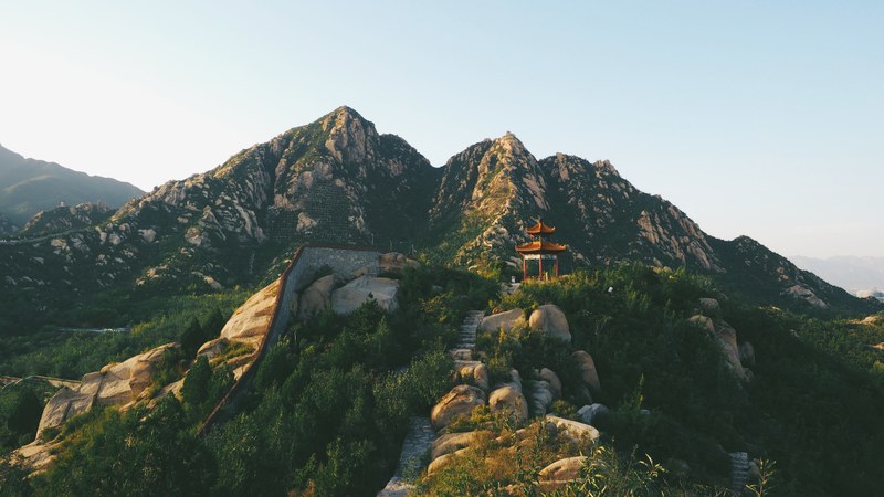 stone stairs up a mountain with a pagoda on the shrub covered slope, stairs up to the pagoda 4k