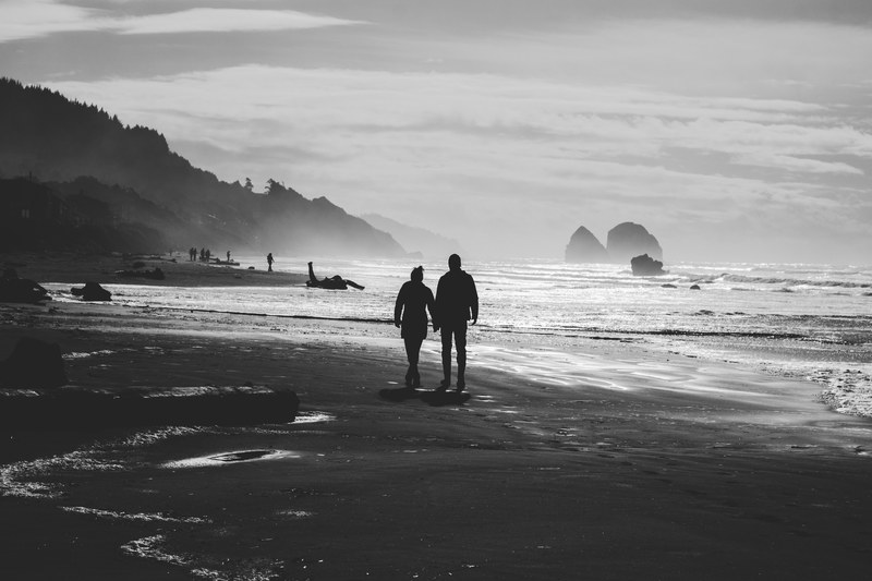 hearty view of a couple holding hands and enjoying a walk on the beach, couple holding hands at beach 4k
