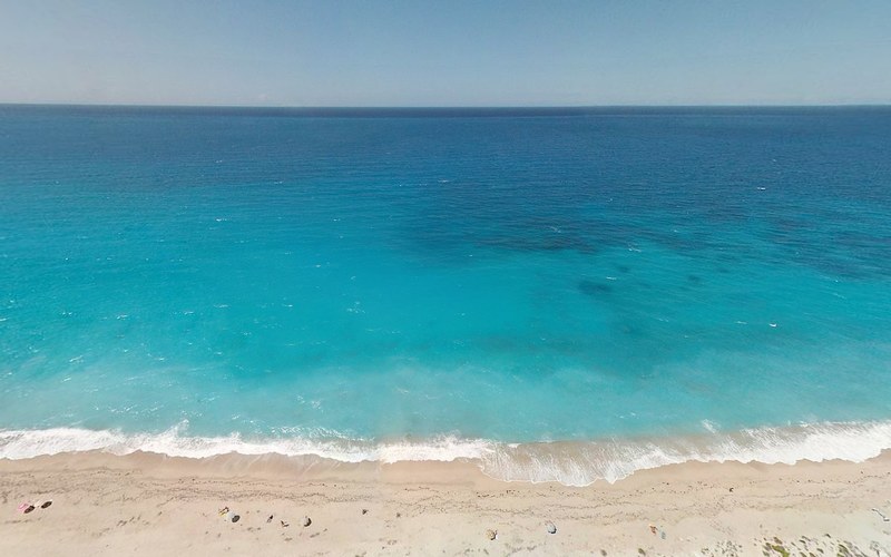 inviting aerial view of blue ocean at beach, beach with blue water 4k