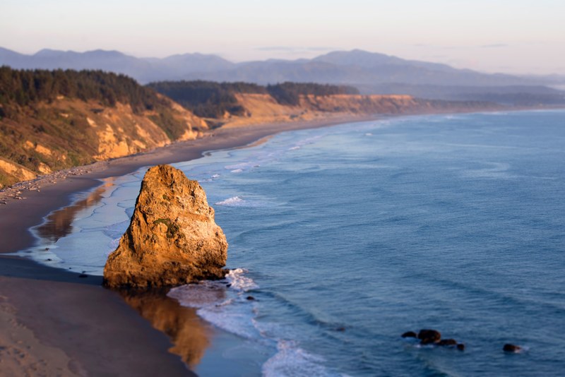 shot of a rock sitting on the ocean coast at beach, ocean coast at beach 4k