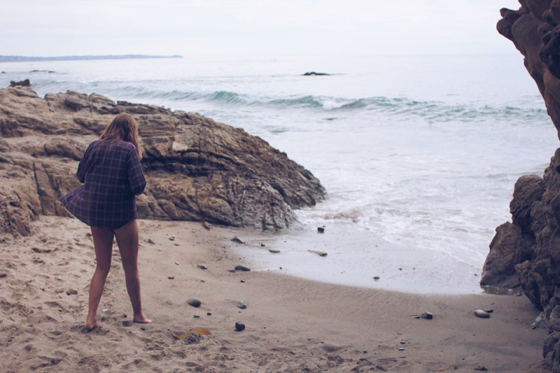 woman on vacation steps out of the cove to relax in the beach shores, relaxing at the beach 4k