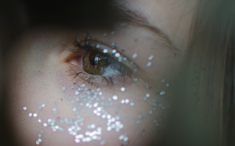 close up of glitter around a womans eye, glitter around an eye 4k
