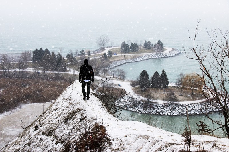 a person walking on a narrow path at scarborough bluffs, exploring the bluffs 4k
