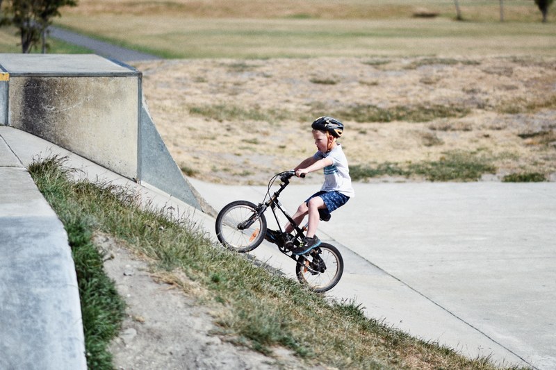 child on bicycle in helmet on concrete ramp, child in helmet on bike 4k