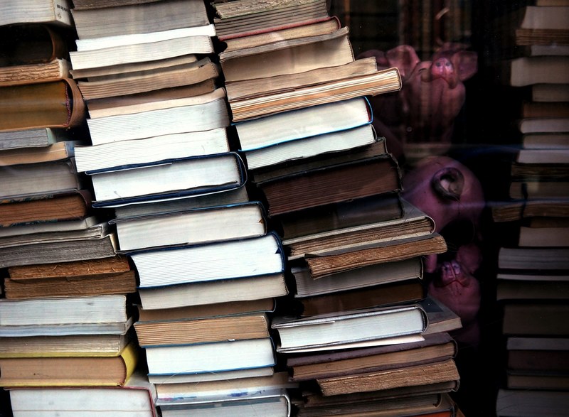 stacks of antique second hand hardback books piled up inside of a store window, _stacks of second hand books 4k