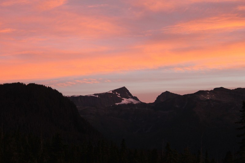 distant black silhouettes of flat mountains covered with snow during sunset, dark mountains at dusk 4k