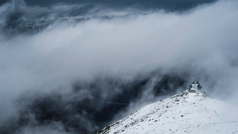 isolated building on the foggy summit of a snowy mountain in jasper, way up stay up 4k