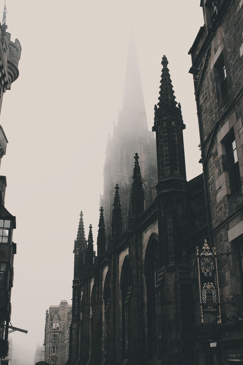 monochromatic gothic cathedrals line the history streets of edinburgh, foggy street in edinburgh 4k